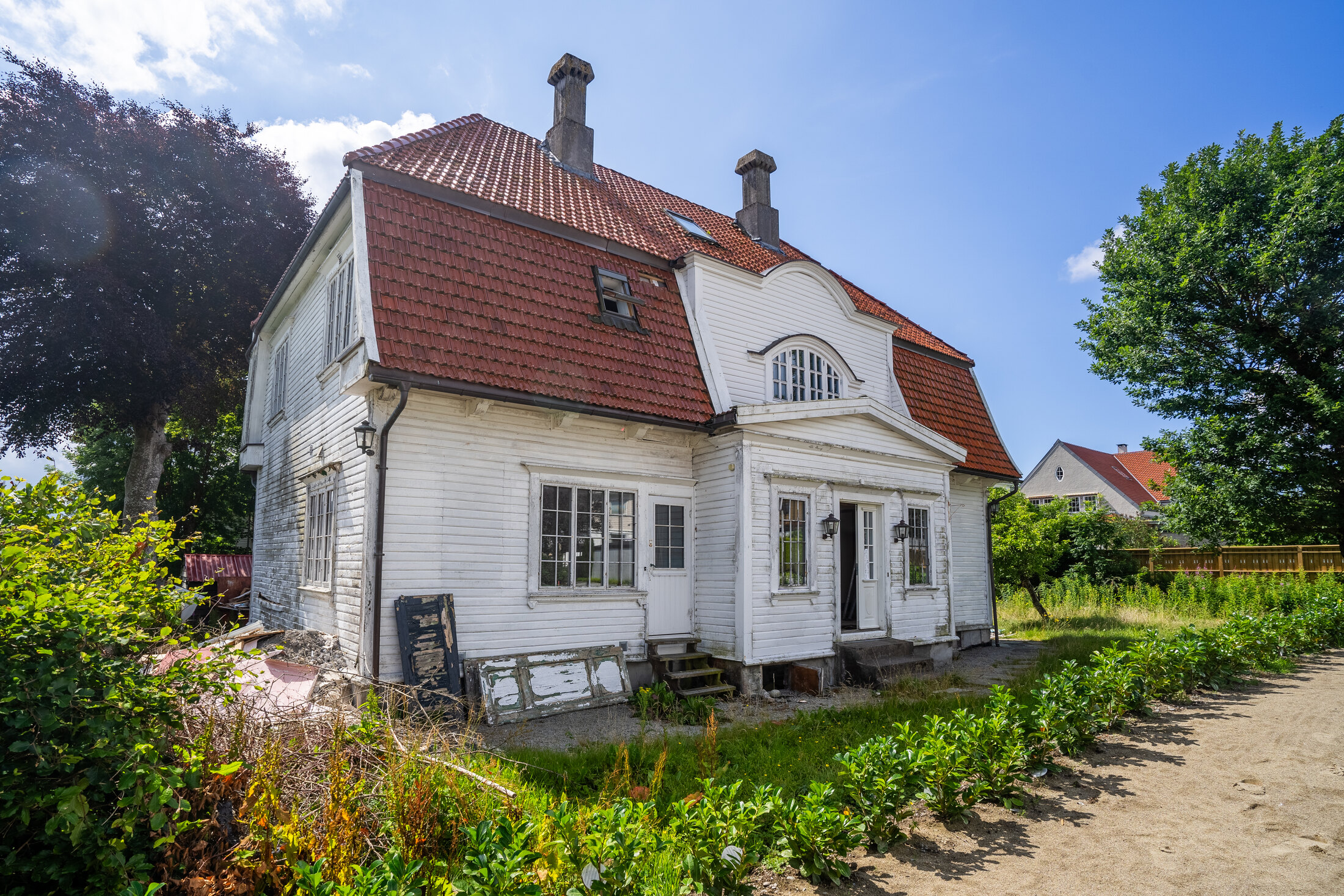 Den gamle villaen før oppstart med gjengrodd hage og slitte utearealer